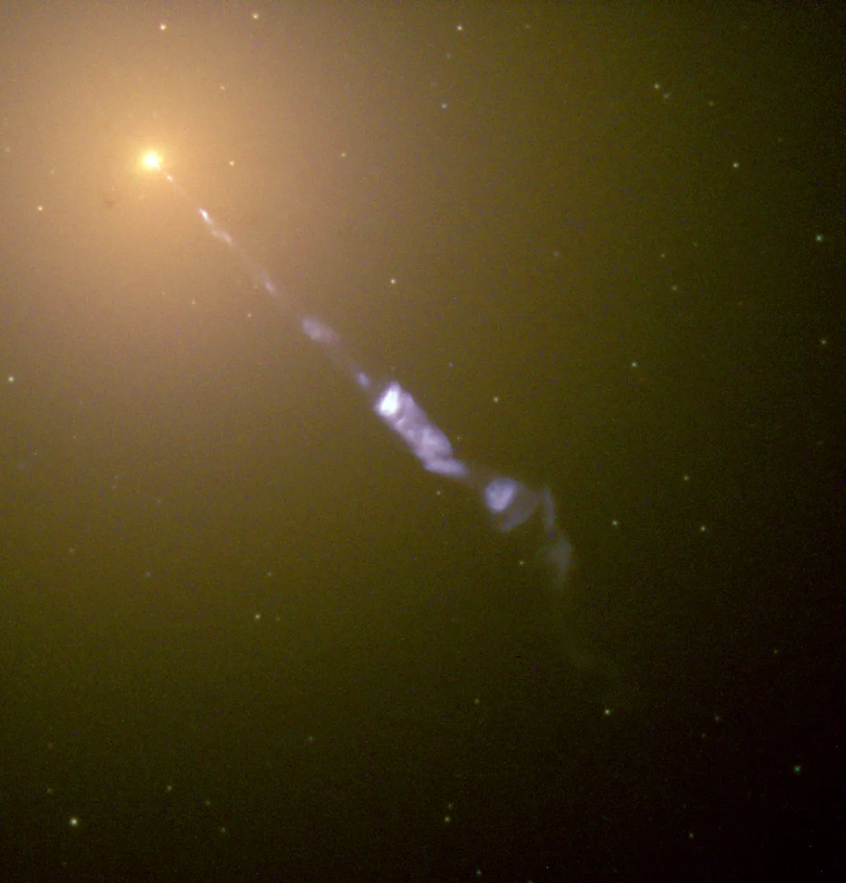 The galaxy M87 with a brilliant blue-white relativistic jet streaming from its glowing core